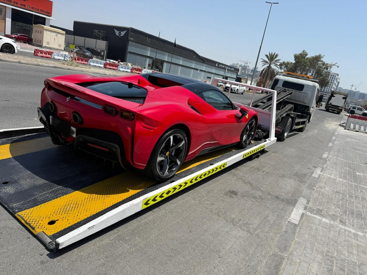 Ferrari SF90 full down recovery loaded level on a flatbed in Dubai
